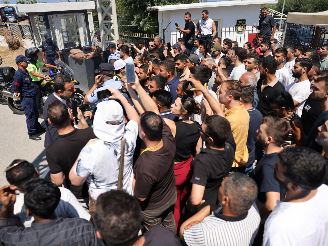 People gather and protest as they wait for an update after the capsize of a passenger boat off the coast of Kyrenia. Photo: Reuters