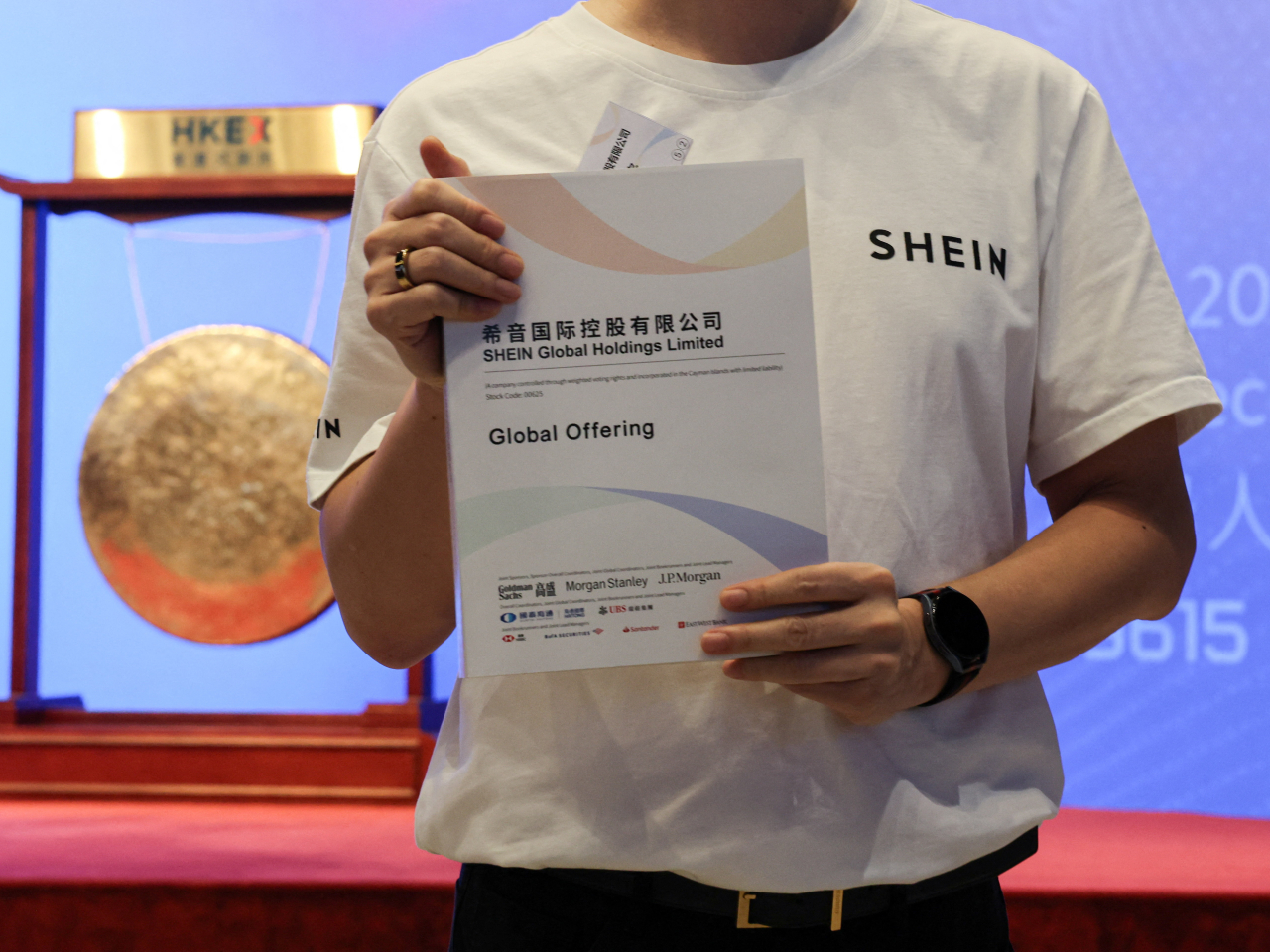 A staff member holds a prospectus during the listing ceremony of online retailer Shein in Hong Kong on Tuesday. Photo: Reuters