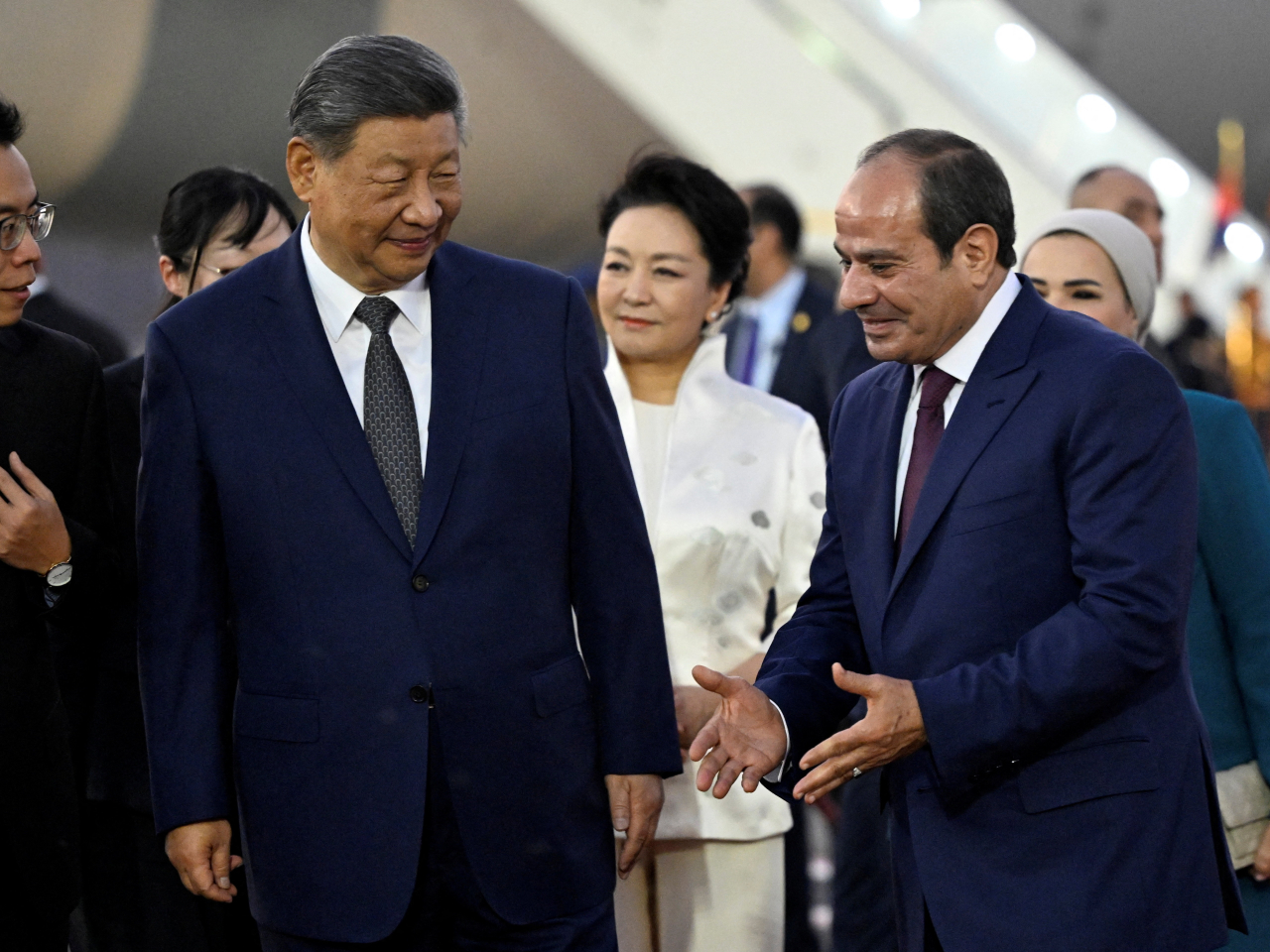President Xi Jinping listens to his Egyptian counterpart Abdel Fattah al-Sisi as First Lady Peng Liyuan watches upon their arrival at Cairo International Airport. Photo: Reuters