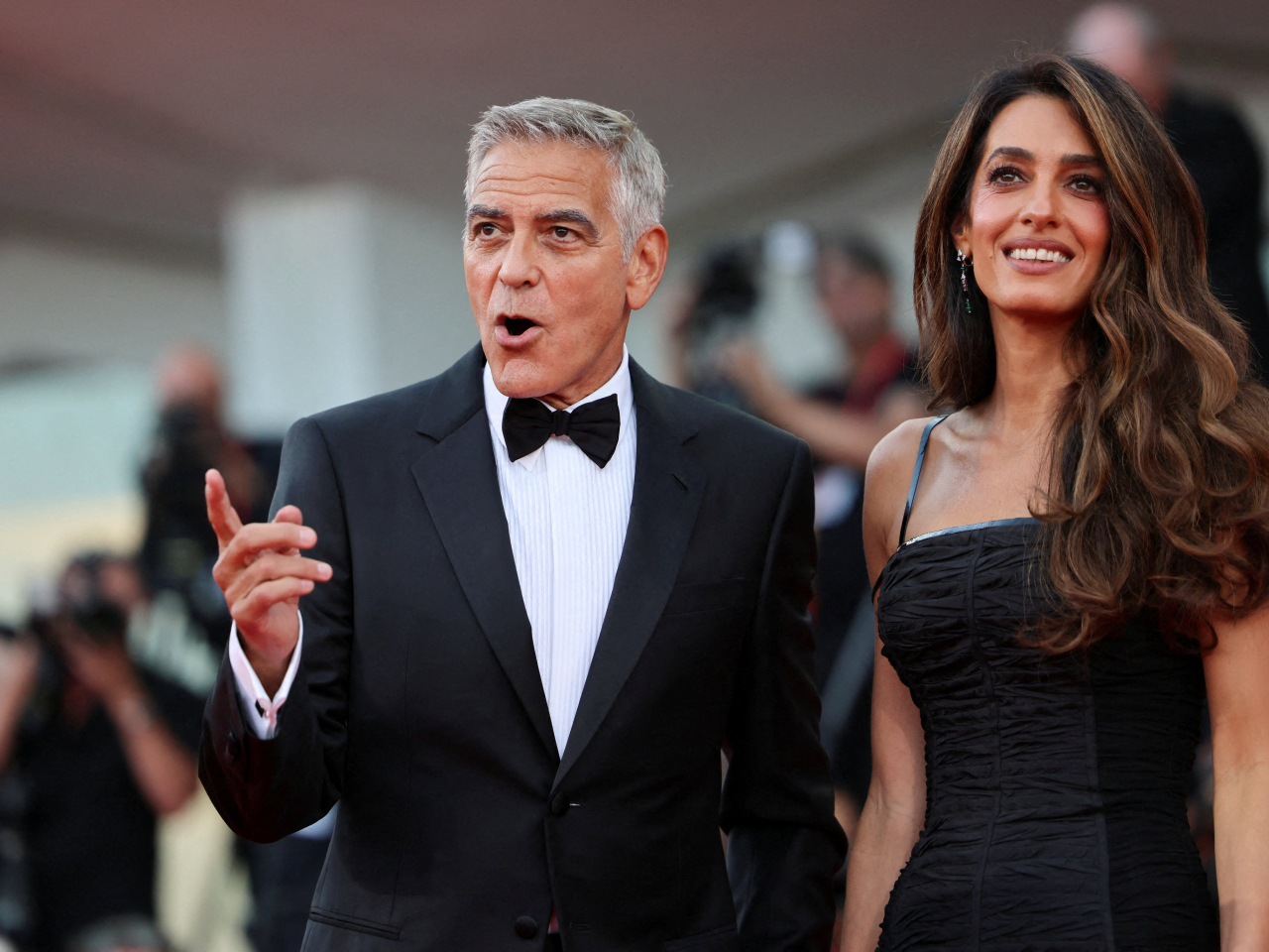 George Clooney and his wife Amal pose on the red carpet before the opening ceremony of the 83rd Venice International Film Festival. Photo: Reuters