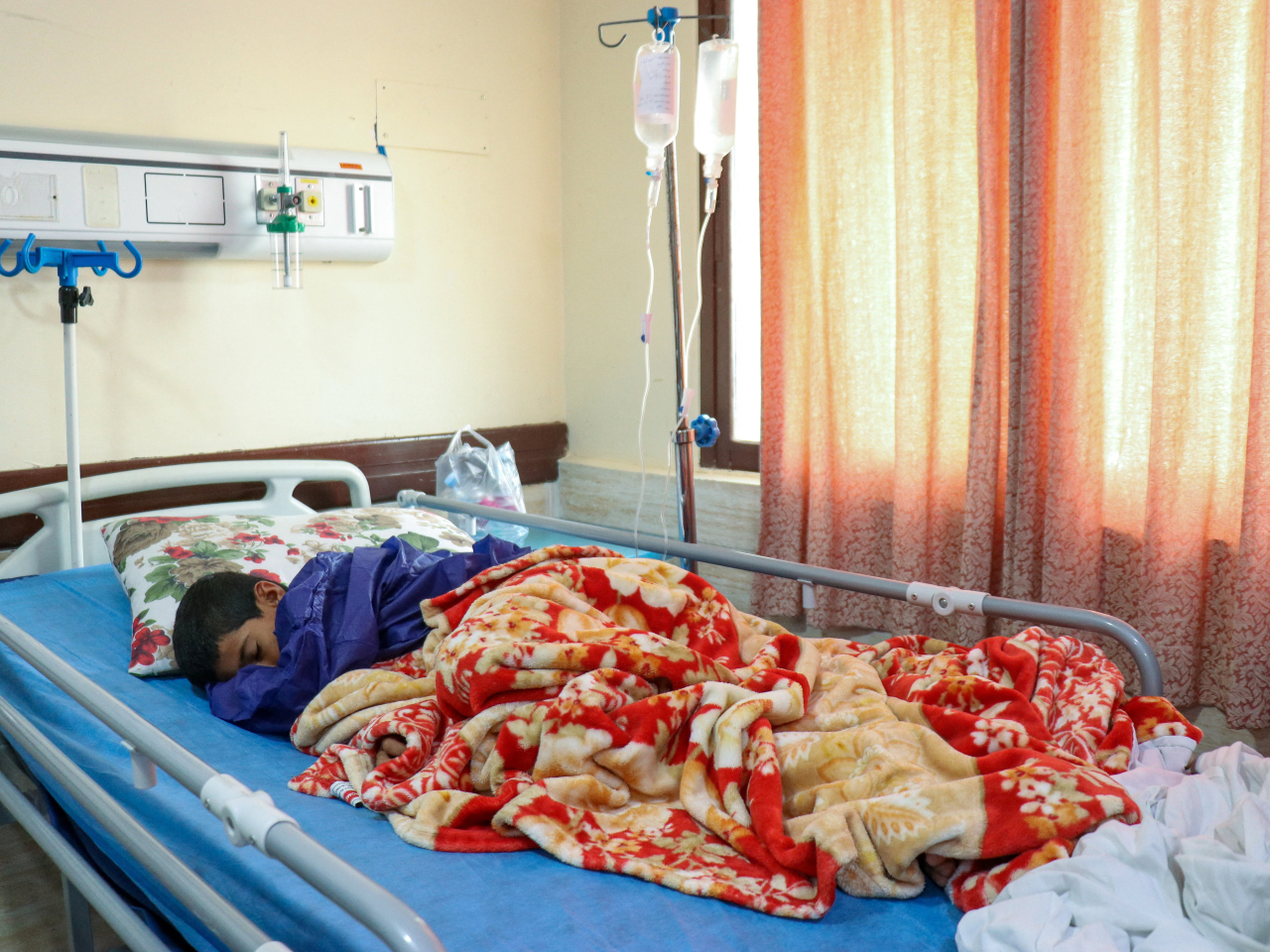 An injured victim lies in a hospital bed following a reported attack near a wedding near Sirik. Photo: Isna via Wana via Reuters