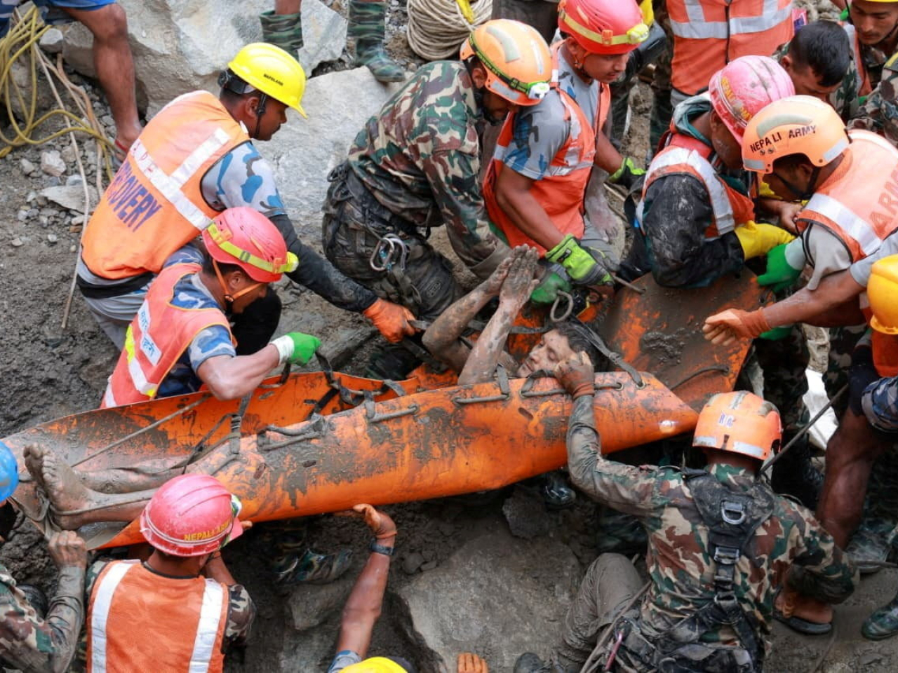 One of the two workers pulled out from a Trishuli-3A Hydropower Project tunnel gives thanks for his rescue. Photo: Reuters