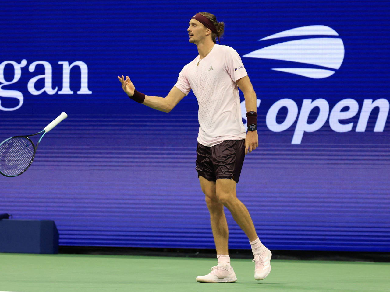 Alexander Zverev drops his racket in a light-hearted touch after heavy-going to beat France's Quentin Halys. Photo: Reuters