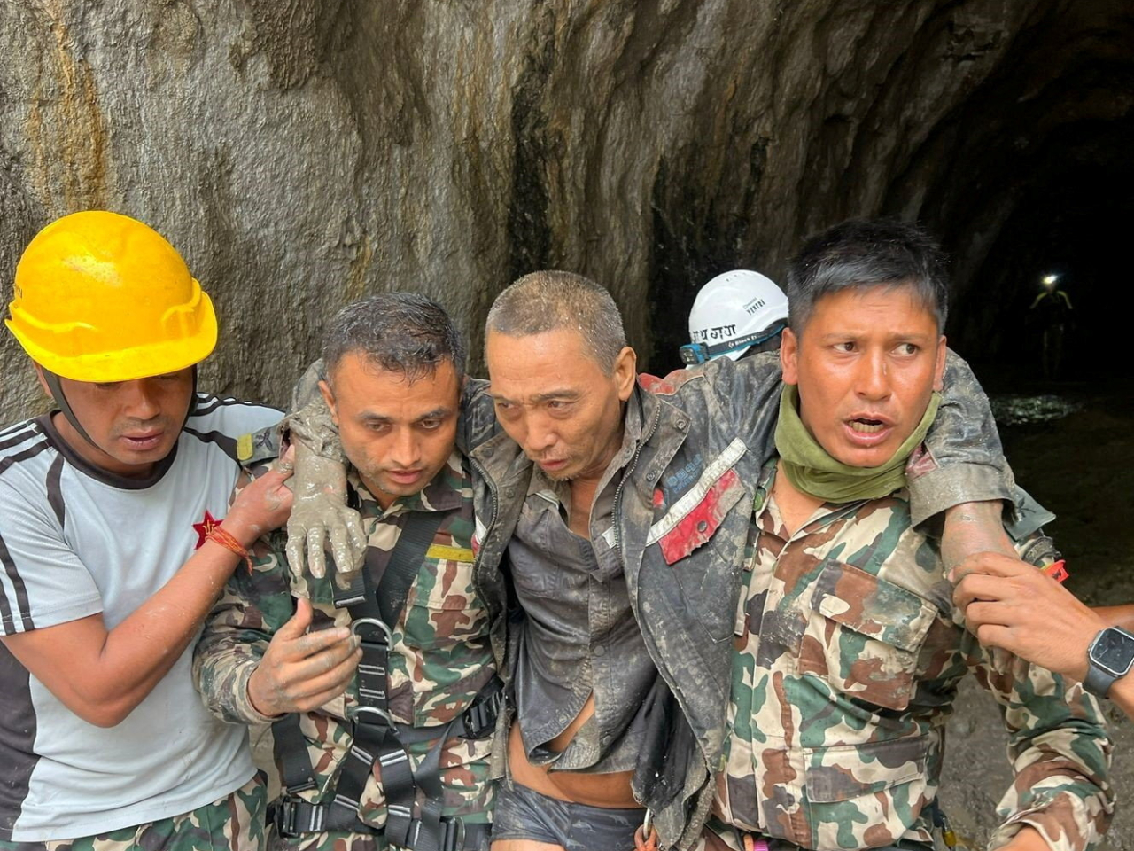 Nepal Army rescuers help the Chinese national out of the Upper Trishuli-1 Hydropower Project tunnel in Rasuwa. Photo: Nepal army handout via Reuters