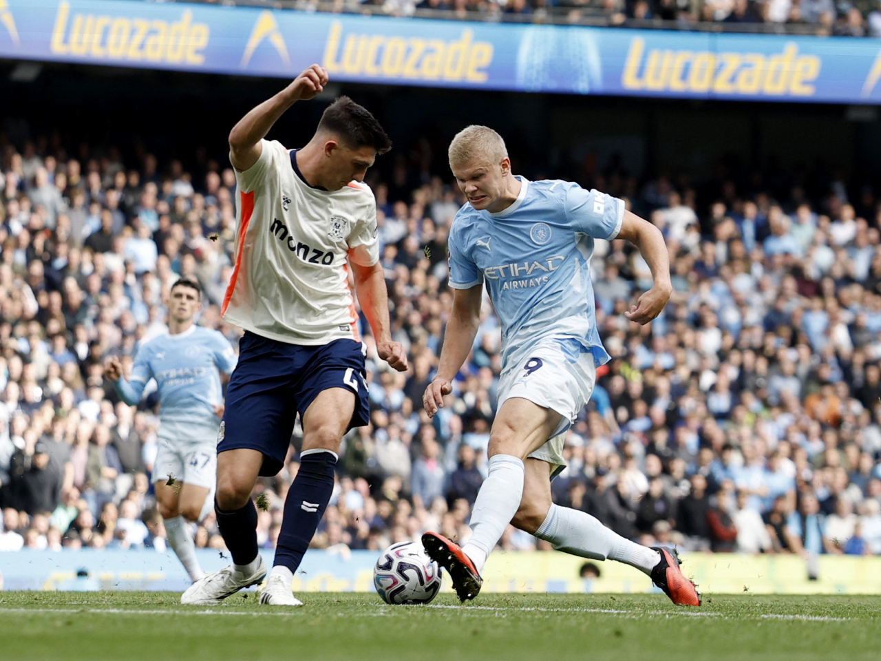 Manchester City's Erling Haaland tussles with Coventry City's Bobby Thomas. Photo: Reuters
