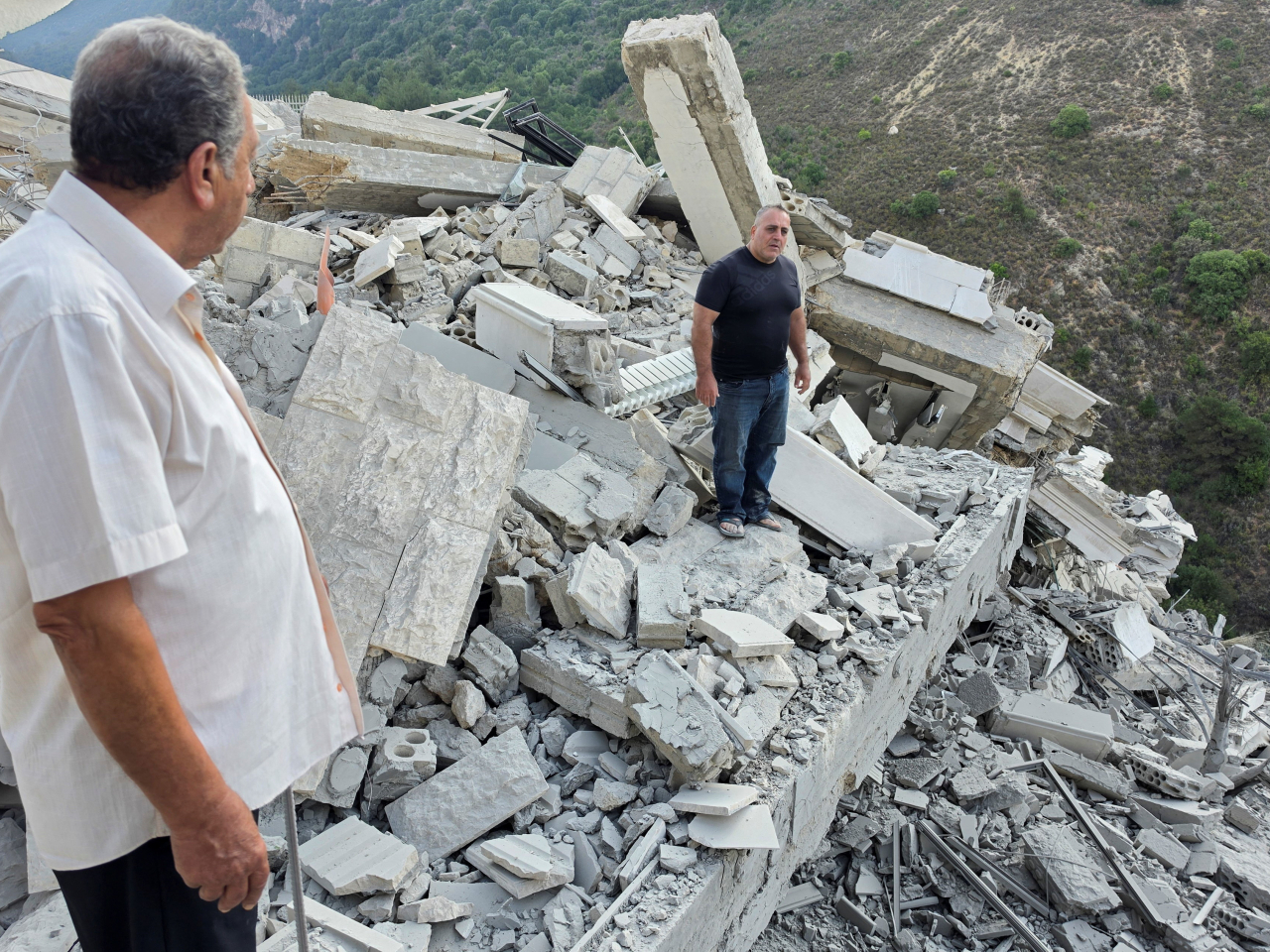 Onlookers inspect the site of an Israeli strike in Arab Salim in Lebanon. Photo: Reuters