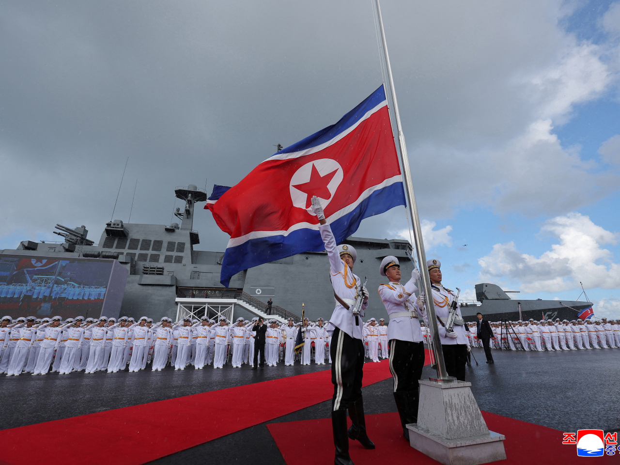 Members of the military raise the DPRK flag during the commissioning ceremony of the destroyer "Kang Kon" at Wonsan Port. Photo: Reuters