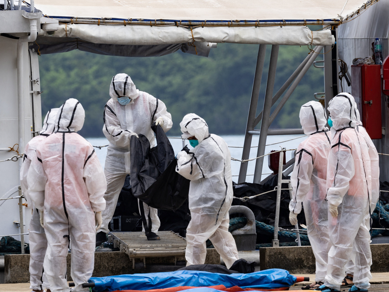 Members of the Philippine Coast Guard carry body bags following the fire aboard the MV June Aster ferry. Photo: Reuters