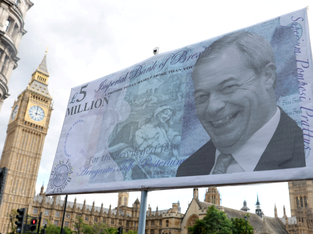 A protest placard criticising the leader of the Reform UK, Nigel Farage, and questioning party donations is displayed near the Houses of Parliament. File photo: Reuters