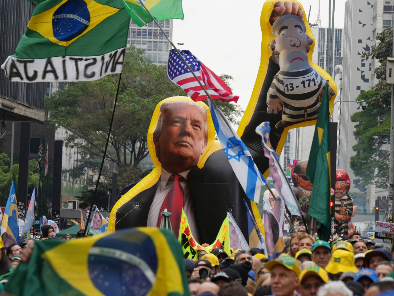 Supporters of Brazilian presidential candidate Flavio Bolsonaro, son of convicted coup plotter Jair Bolsonaro, hold a Donald Trump inflatable at a Sao Paulo rally. File photo: Reuters