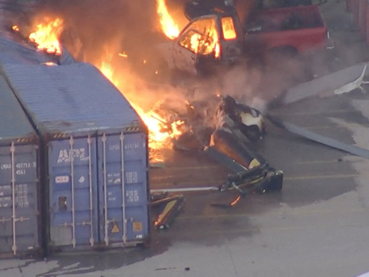 At least four cars and two storage containers on the ground burned after the helicopter caught fire. Photo: ABC Affiliate KABC via Reuters