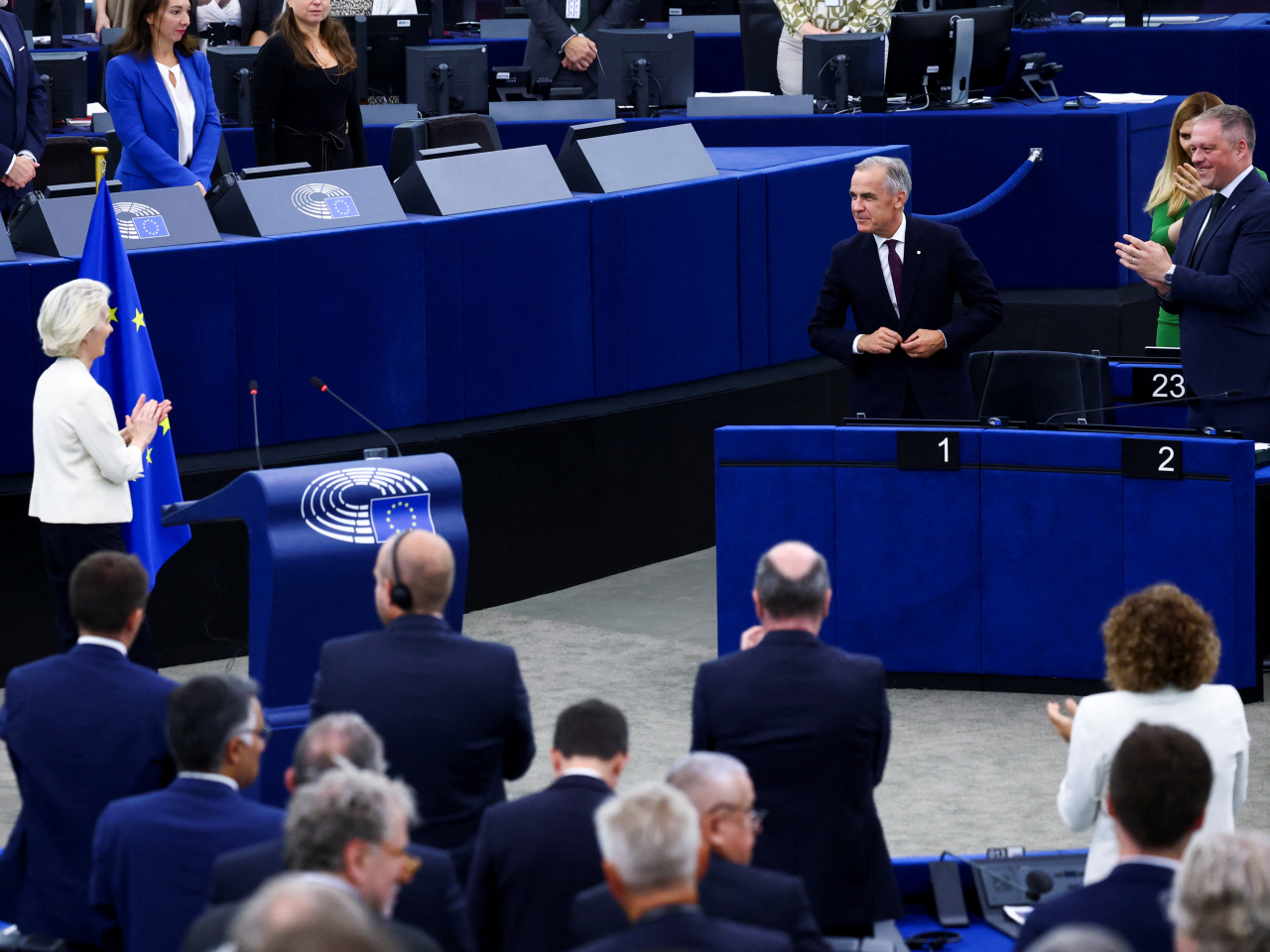 Mark Carney rises as he gets a standing ovation from a European parliament as Ursula von der Leyen makes her state of the union speech. Photo: Reuters