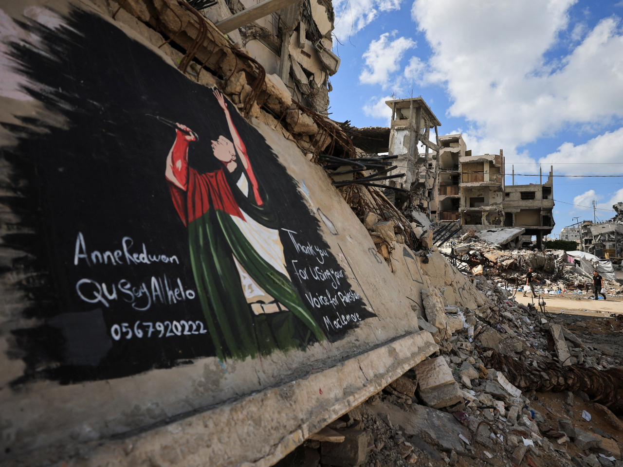 Palestinians walk near a mural painted to honour American rapper Macklemore on Friday. Photo: Reuters