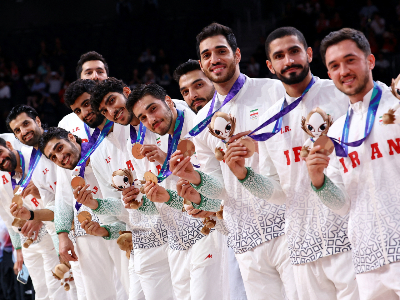 Bronze medallists, Iran celebrate on the podium. Photo: Reuters
