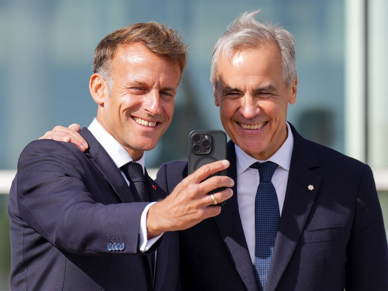 France's President Emmanuel Macron and Canada's Prime Minister Mark Carney pose for a selfie as they meet in the small French territory of Saint Pierre and Miquelon. Photo: Reuters
