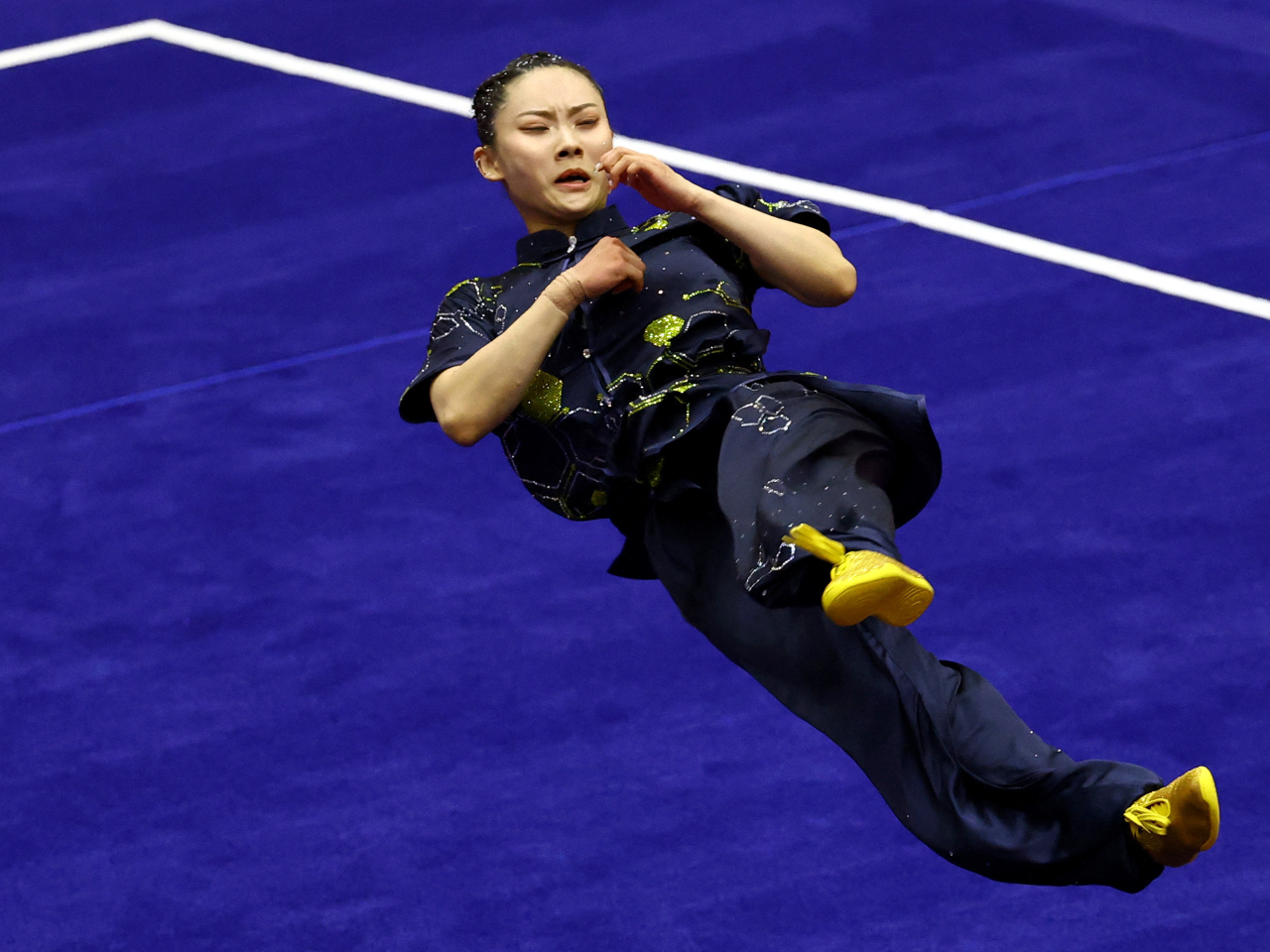 Wushu star Lydia Sham held off a late challenge from Macau's Sou Cho-man to win the women's changquan final. Photo: Reuters