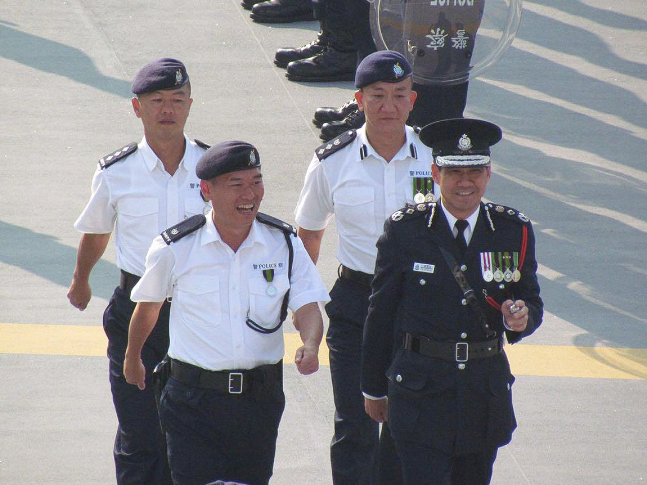 簡啟思（前排左）當年擔任機動部隊大隊長期間，陪伴時任警務處處長鄧竟成在結業儀式檢閱。（警方提供）