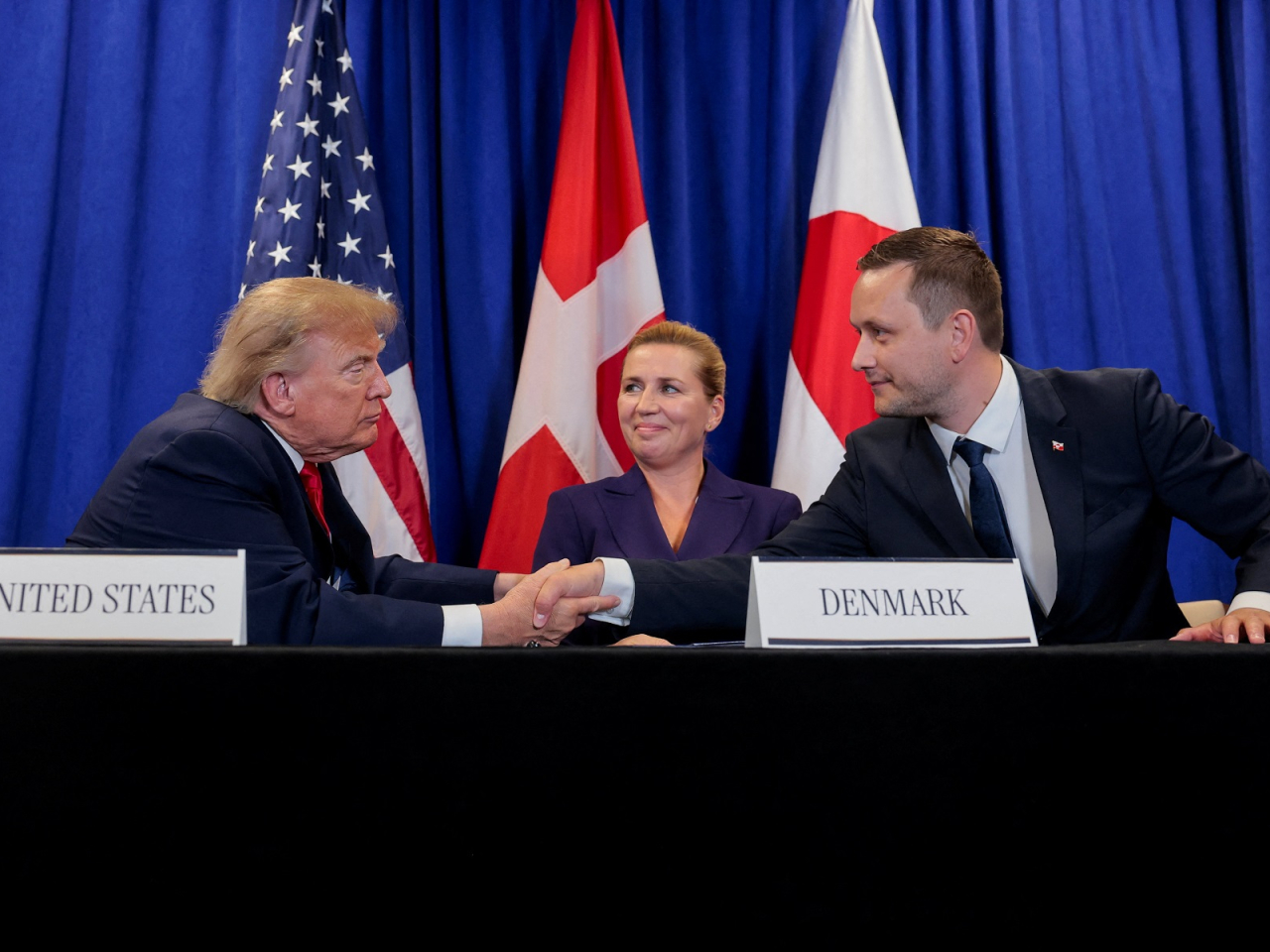 US President Donald Trump shakes hands with Greenland Prime Minister Jens-Frederik Nielsen as Danish Prime Minister Mette Frederiksen looks on at a signing event in New York. Photo: Reuters