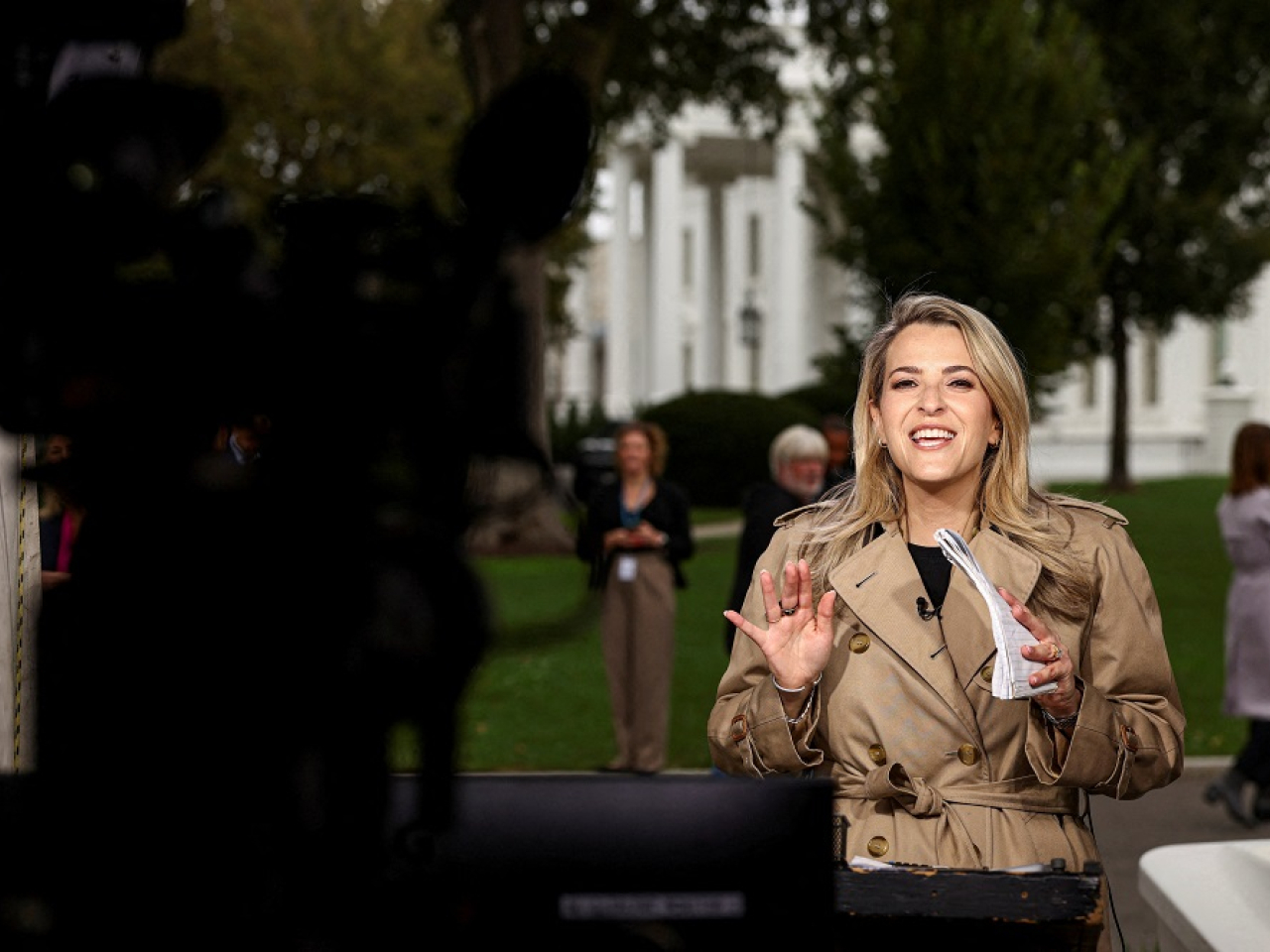In a show of solidarity, journalists from other news outlets filmed reporter Betsy Klein as she reported live following her return. Photo: Reuters
