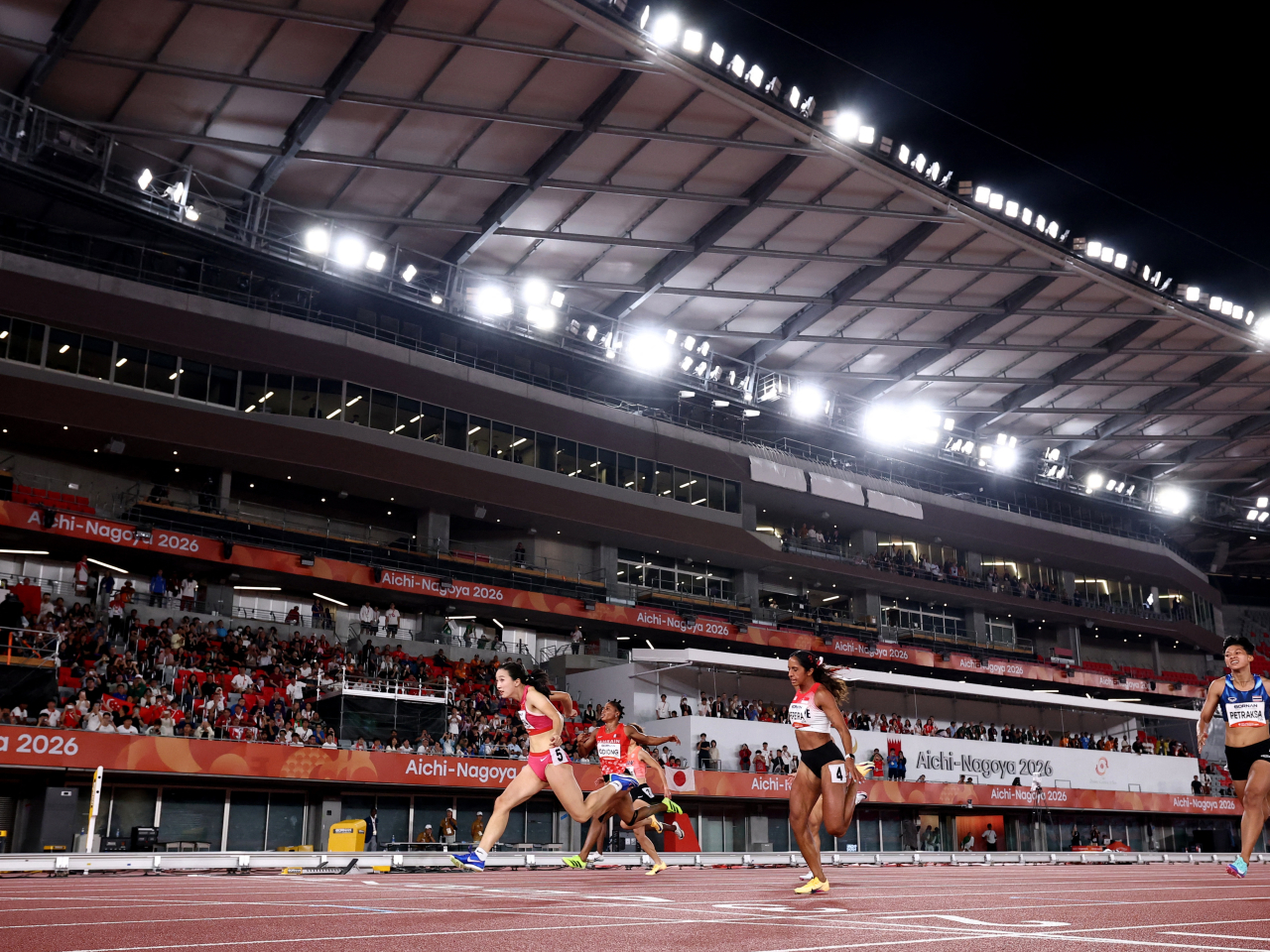 Yujie Chen crosses the finish line to win the women's 100 metres in a Games-record time. Photo: Reuters