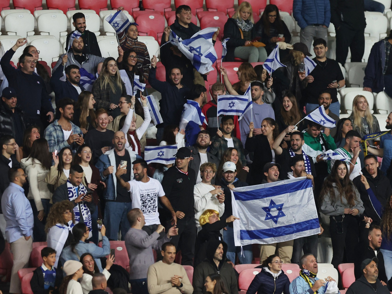 Israeli fans wave flags during the match. Photo: Reuters