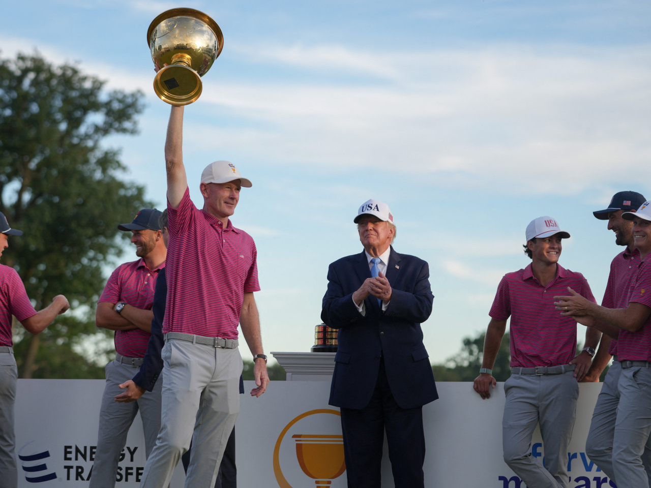 US President Donald Trump applauds during the trophy ceremony after the US team won the Presidents Cup golf tournament at Medinah Country Club. Photo: Reuters