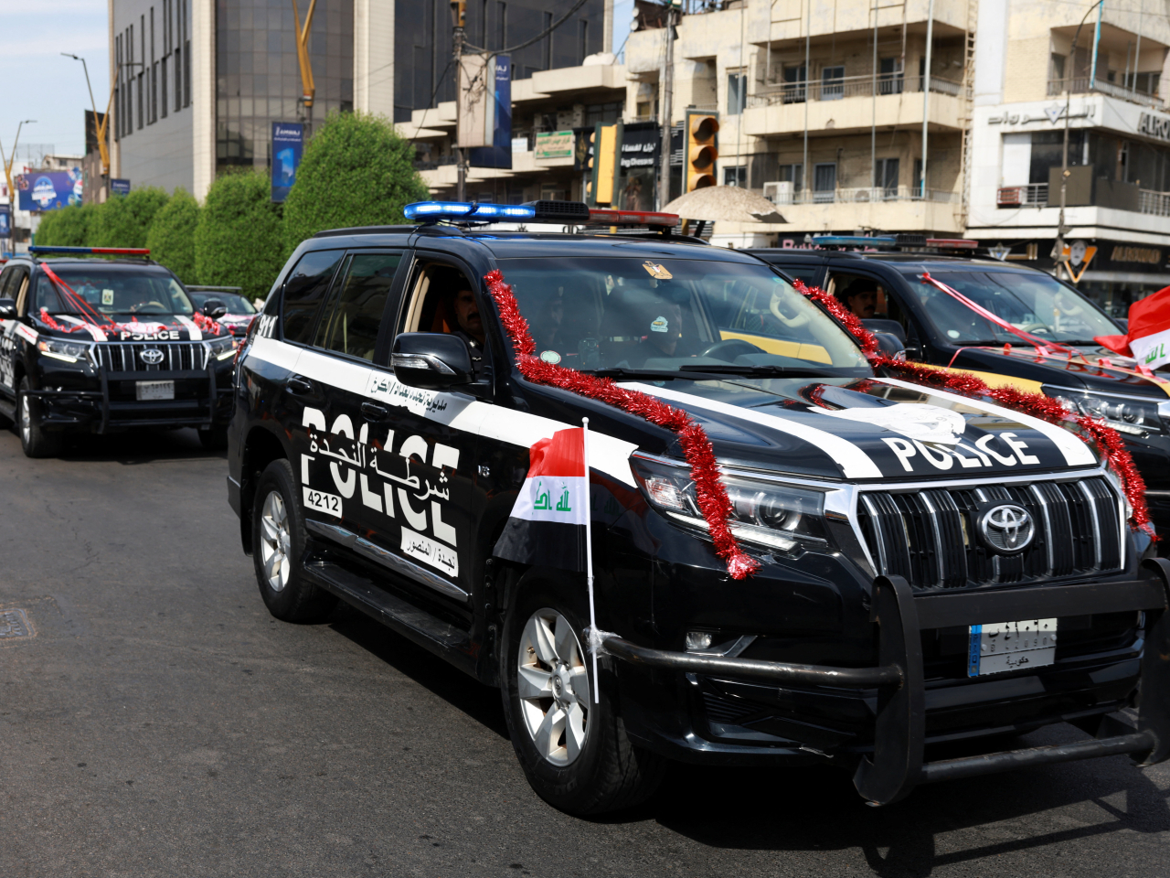 Members of the Iraqi security forces drive in a convoy through Baghdad as they celebrate the withdrawal of US-led coalition forces from Iraq. Photo: Reuters