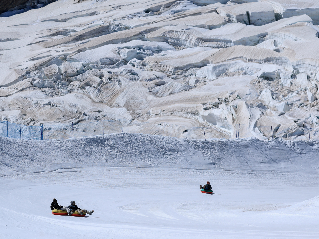 Tourists snow tube at Jungfraujoch, a glacier saddle near Grindelwald in Switzerland. File photo: Reuters