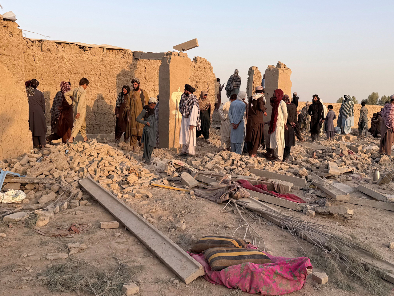Afghans stand on the rubble of a house hit in what the Taliban said was a Pakistani airstrike in Garmsir, Helmand province. Photo: Reuters