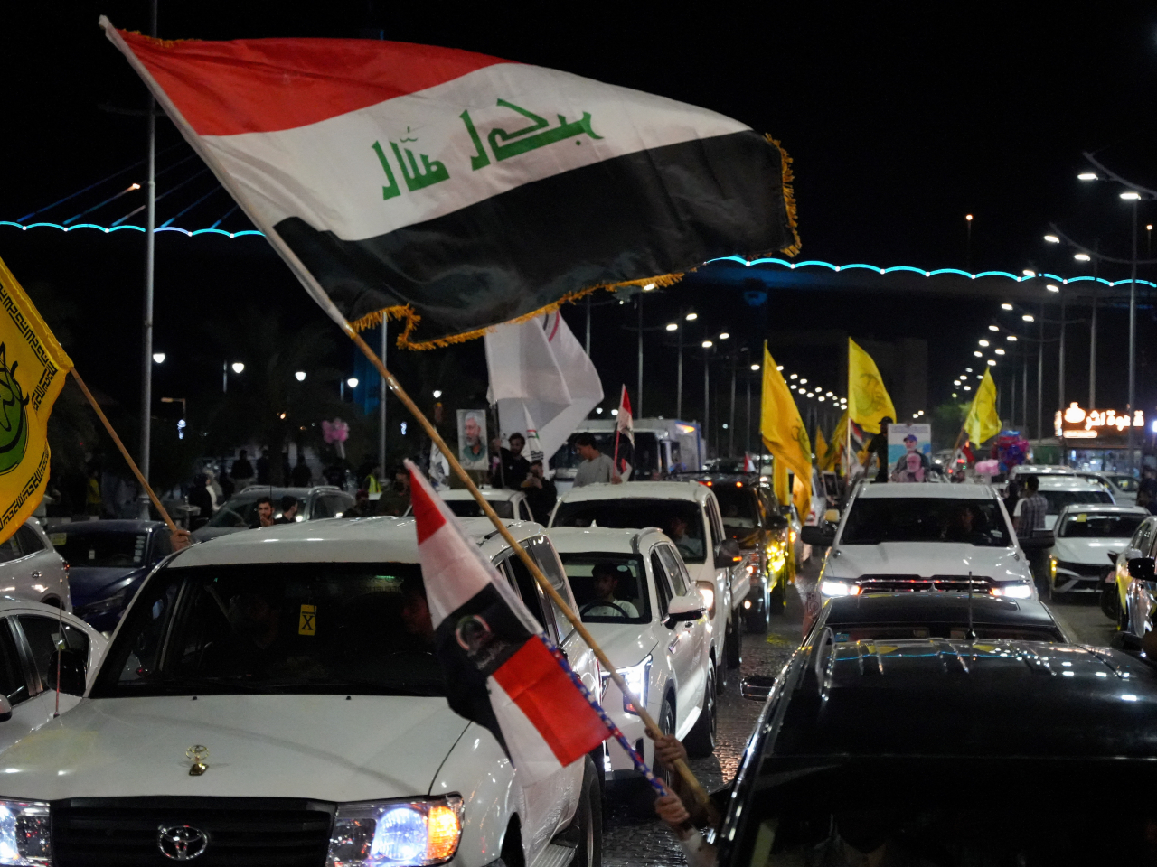 Supporters of a Shi'ite armed group celebrate the withdrawal of US-led coalition forces in Basra, Iraq. Photo: Reuters