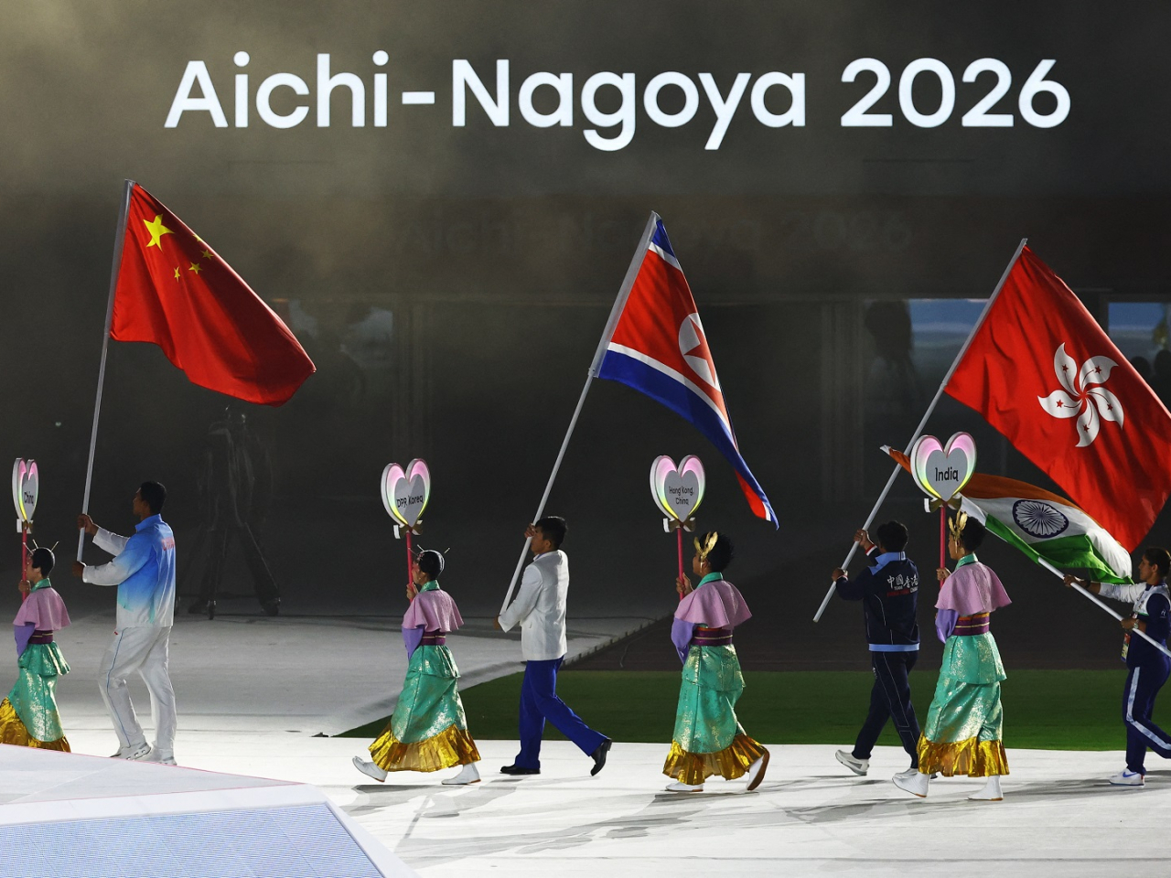 Cado Lee is the flag bearer for the SAR at the closing ceremony. Photo: Reuters