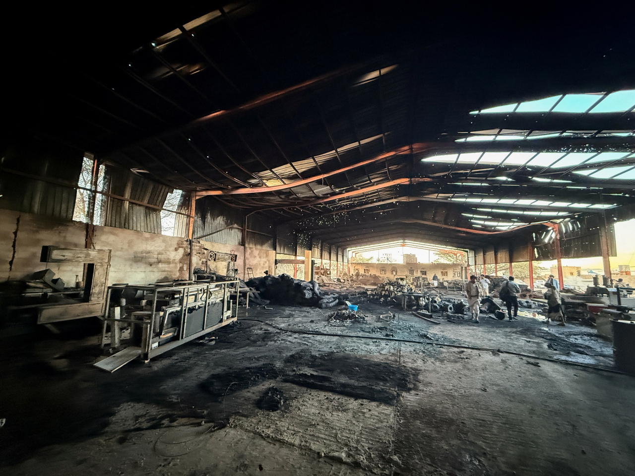 People inspect damage at a factory hit by an airstrike in Sanaa. Photo: Reuters