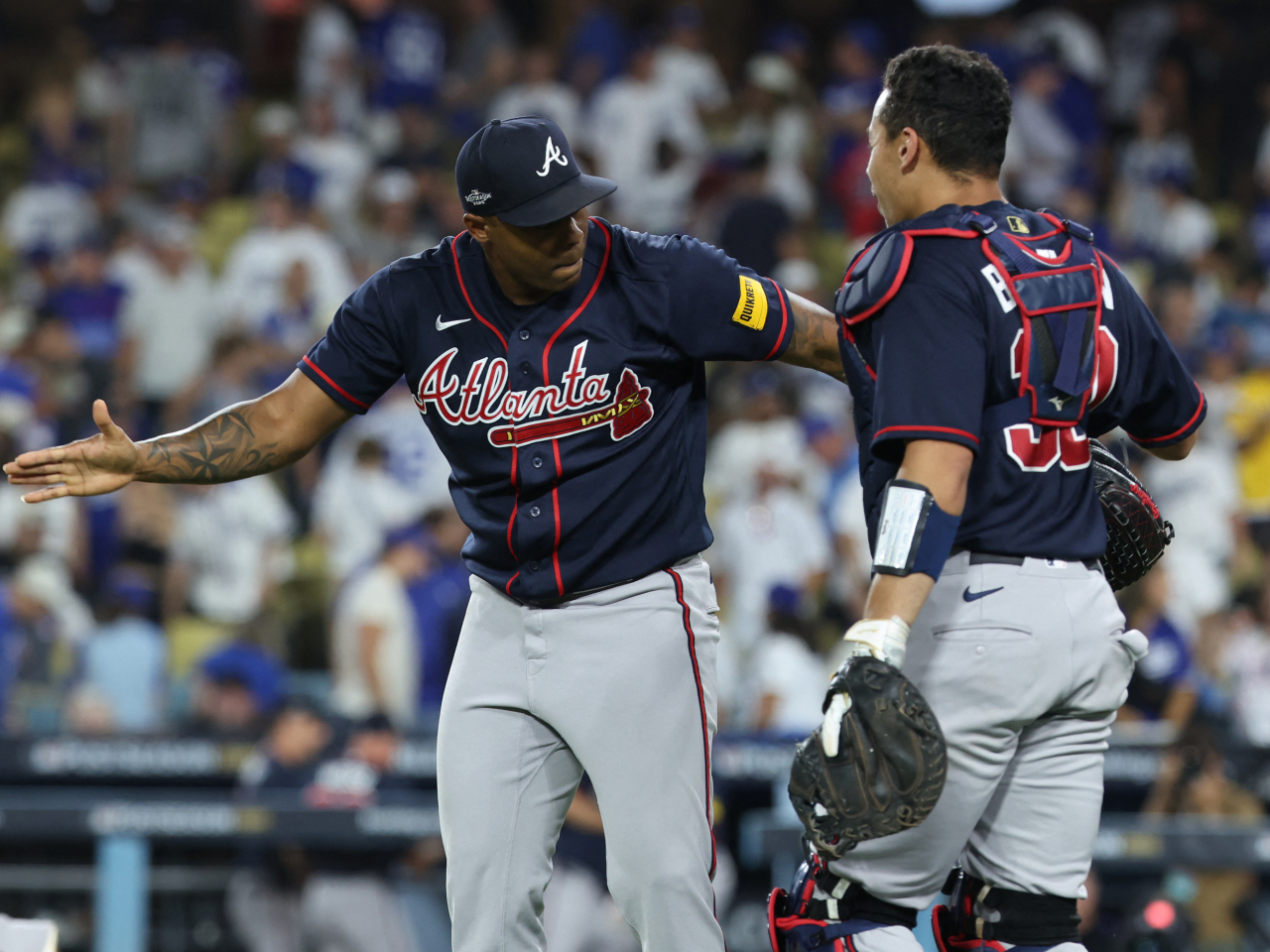Atlanta Braves pitcher Raisel Iglesias (26) celebrates with catcher Drake Baldwin (30) after defeating the Los Angeles Dodgers in game two of the NLDS for the 2026 MLB Playoffs. Photo: Reuters