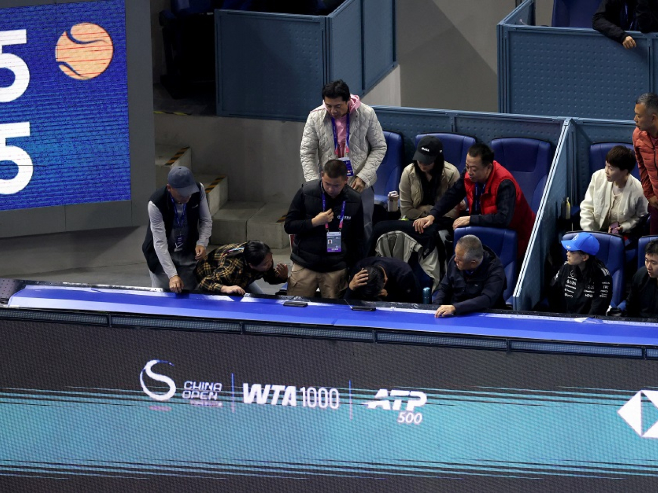 A spectator holds his face after Medvedev hit the ball into the crowd and got himself disqualified. Photo: Reuters