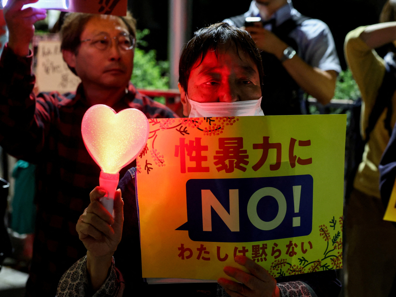 A demonstrator holds a placard during a protest following the killing of a Japanese woman in Okinawa, allegedly by a US marine stationed on the island. Photo: Reuters