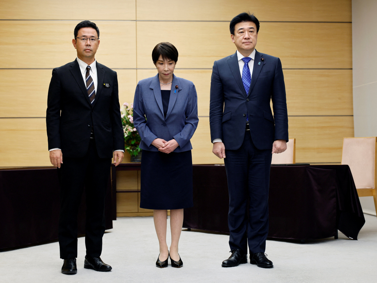 沖繩縣知事古謝玄太（左）就駐沖繩美軍士兵涉嫌搶劫殺人案，向首相高市早苗（中）提出抗議。（路透社）