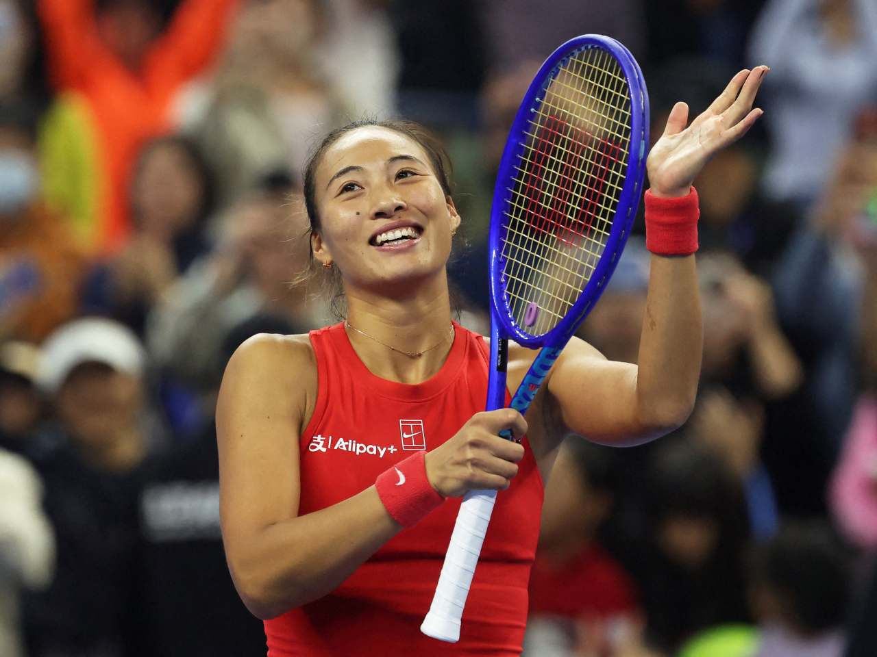 Zheng Qinwen celebrates after winning her semi final match, in Beijing. Photo: Reuters