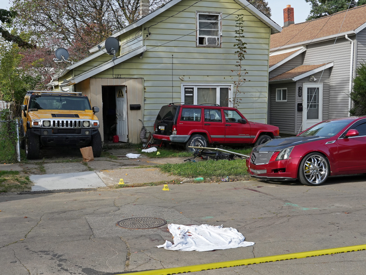 A bloodied sheet lies behind police barrier tape at a house where nine people were confirmed dead in what was described as a mass shooting in Erie, Pennsylvania. Photo: Reuters