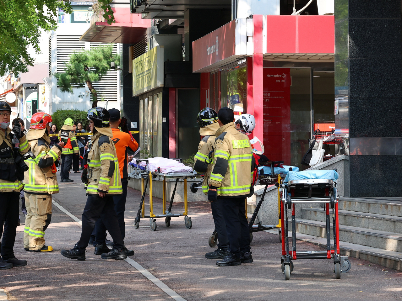 Emergency responders wait on standby near the supermarket in Incheon. Photo: Yonhap via Reuters