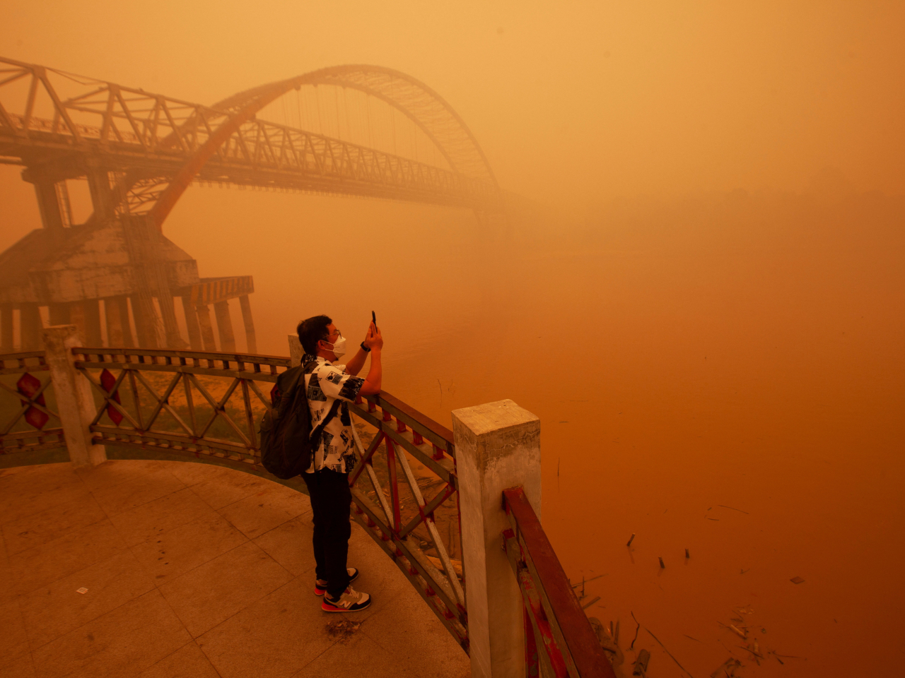 A man is assured of only a hazy picture on the bank of the Kahayan River in central Kalimantan, Indonesia. Photo: Reuters