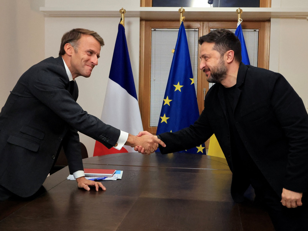 Ukraine's President Volodymyr Zelensky shakes hands with French President Emmanuel Macron ahead of a meeting in Brussels. Photo: Reuters