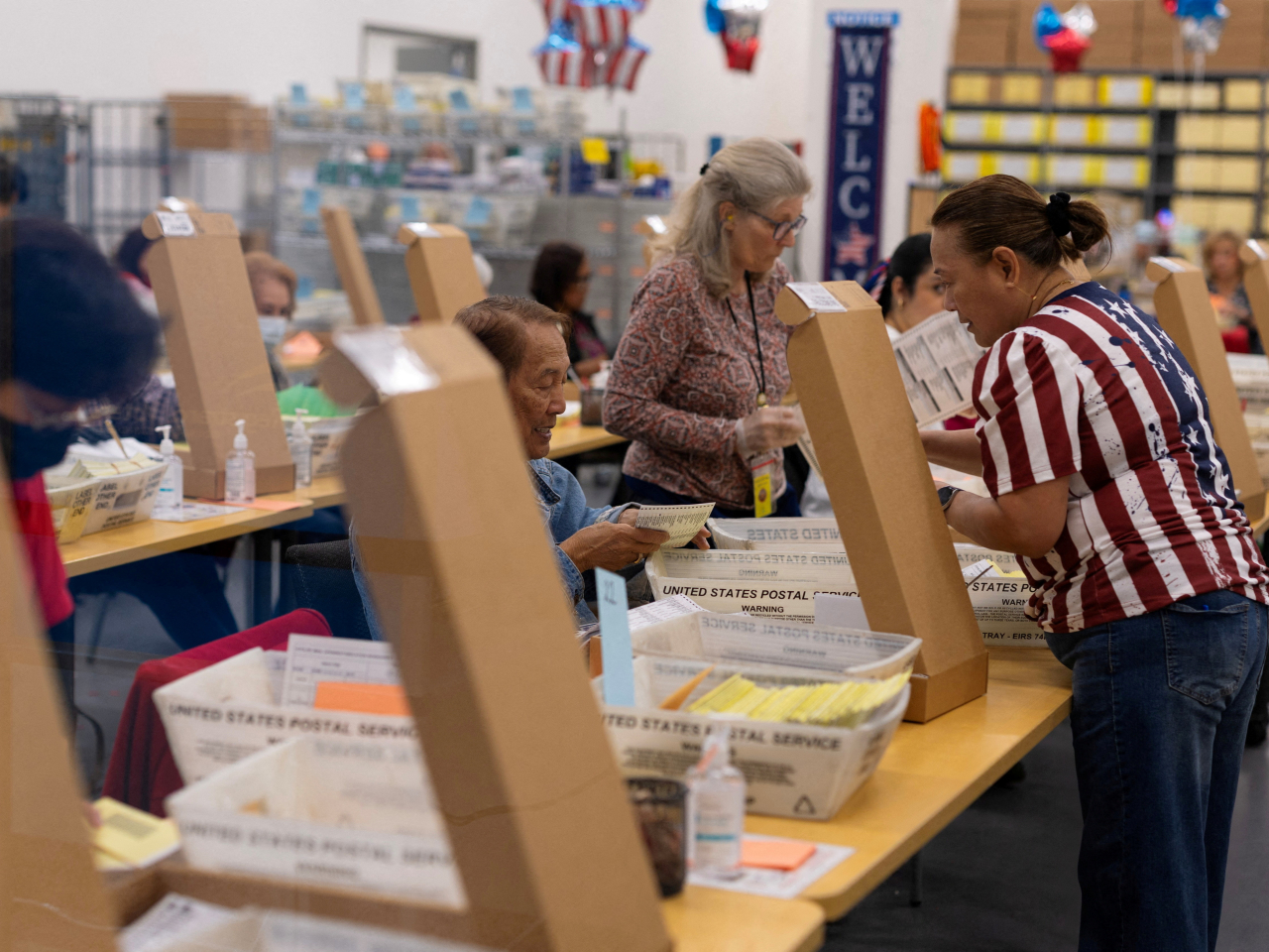 Election workers extract mail-in ballots during the California primary election in San Diego. File photo: Reuters