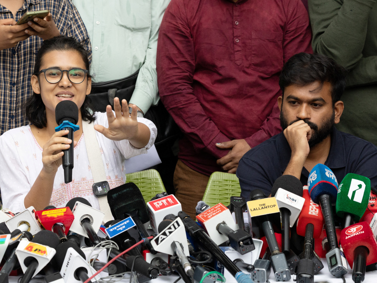 All India Students' Association chief Neha Bora answers a question as Abhijeet Dipke looks on during a press briefing. File photo: Reuters