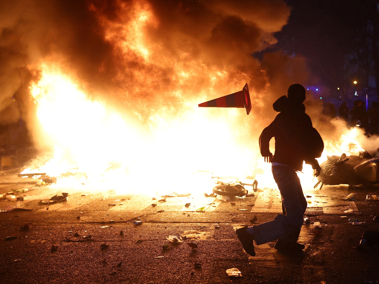 Protesters set debris on fire and block a street in Paris amid clashes during a day of demonstrations against the cost of living and rising fuel prices. Photo: Reuters
