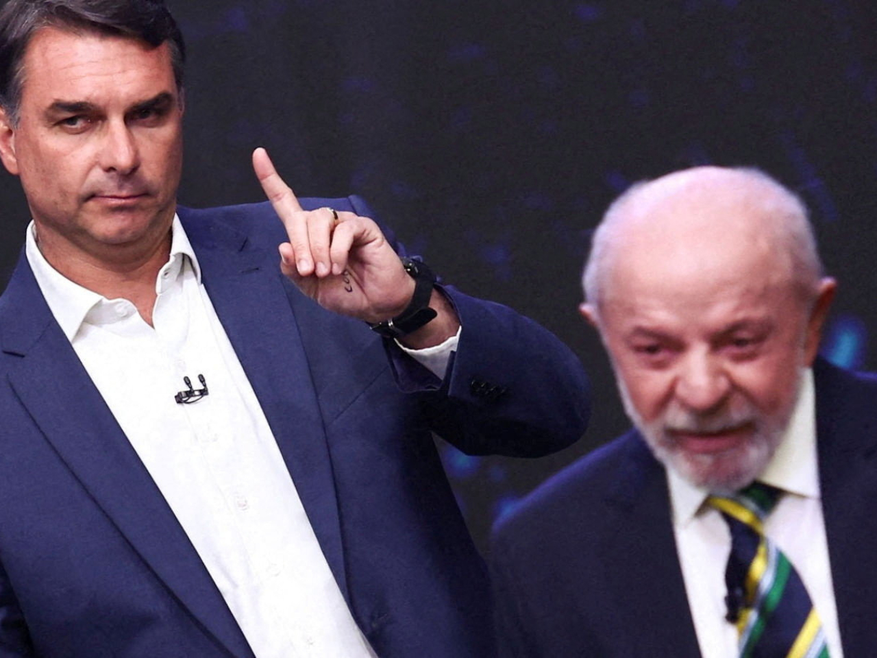 Flavio Bolsonaro borrows a page from Donald Trump's election debate playbook by pacing behind Inacio Lula da Silva when he spoke. Photo: Reuters