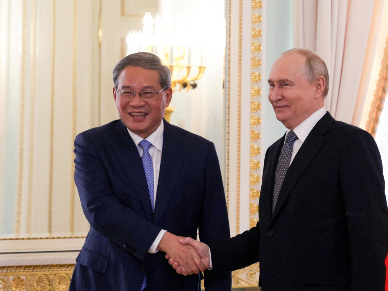 Premier Li Qiang shakes hands with Russian President Vladimir Putin during a meeting in St Petersburg. Photo: Sputnuk via Reuters