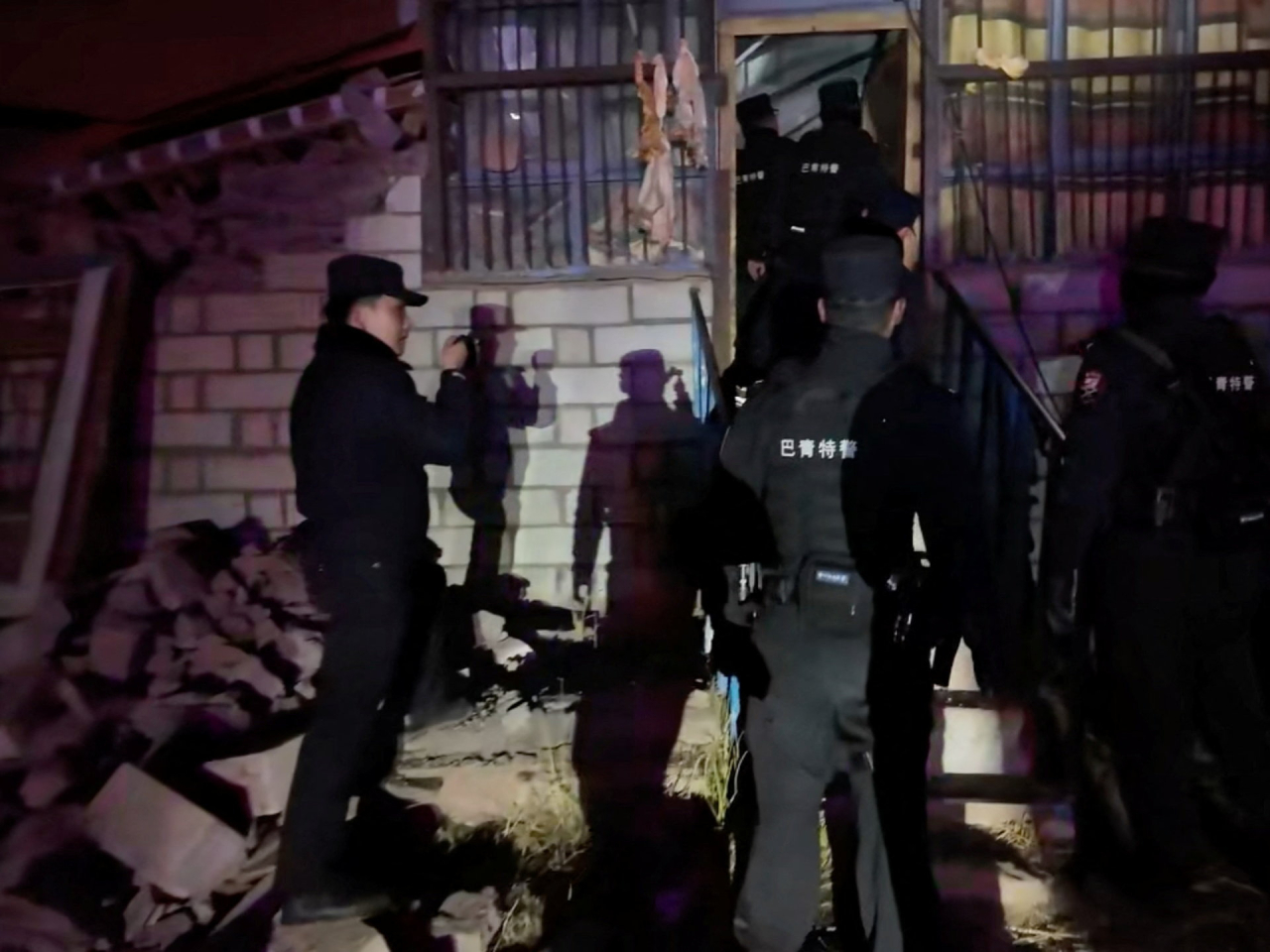 Emergency rescue personnel check a building in Nagqu, Xizang. Photo: Nagqu police department via Reuters