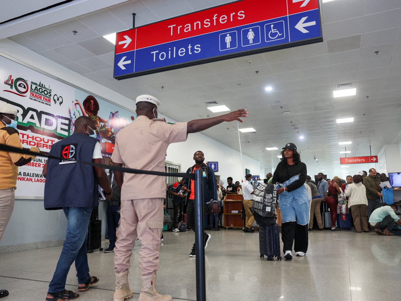 Travellers are directed to a health screening station at an airport in Lagos following reports of an Ebola case in Nigeria. Photo: Reuters