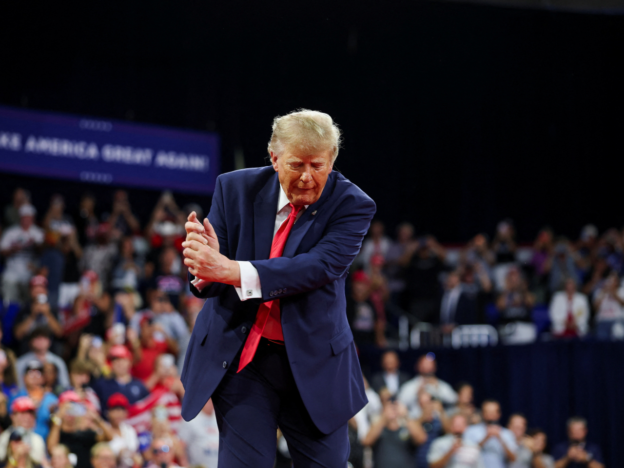 Donald Trump plays to the Florida rally crowd by mimicking a hit from one of his favourite games. Photo: Reuters