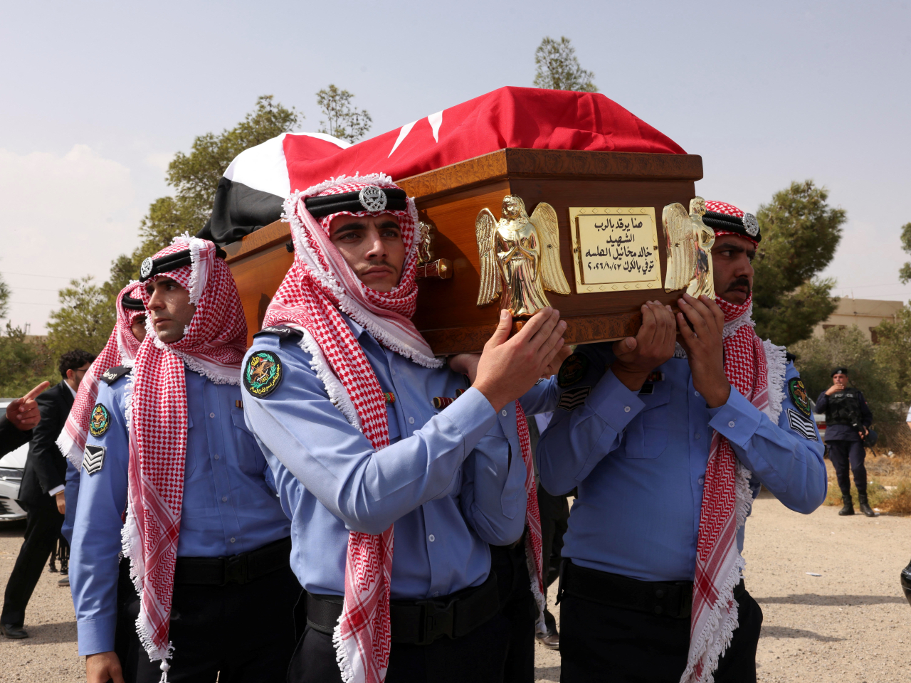 A victim of the attack on a funeral held at the Greek Orthodox church in Karak is borne to a resting place. Photo: Reuters